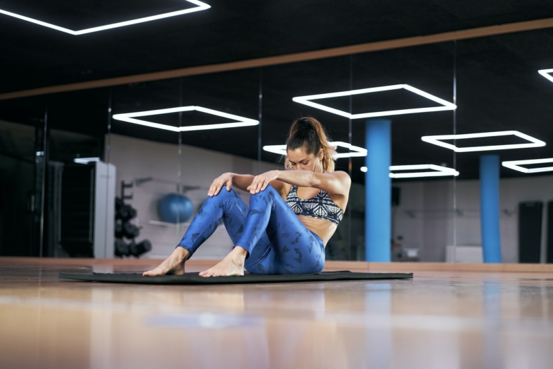 Attractive young woman practicing yoga or pilates in a gym,