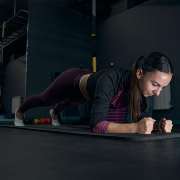 Focused photo on young woman doing yoga exercise