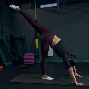 Kind brunette woman standing in yoga pose
